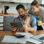 family at table looking at tablet