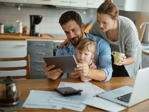 family at table looking at tablet