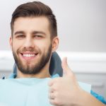 man in dental chair giving thumbs up no dental anxiety