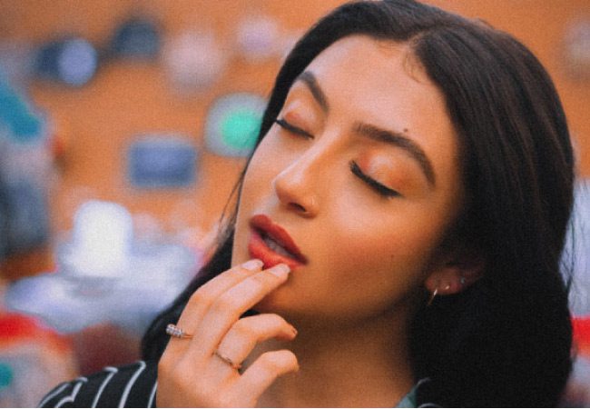 woman holding her lower jaw concerned with gingivitis